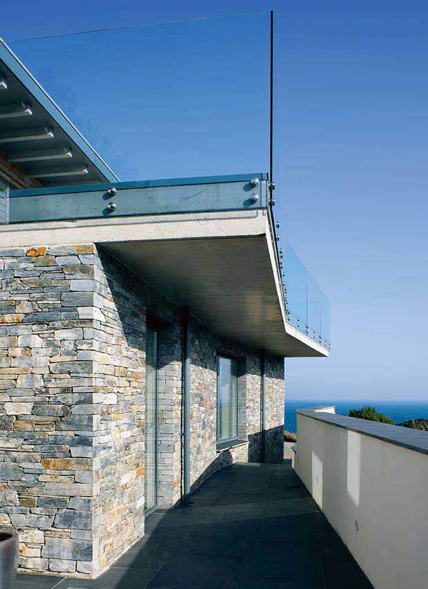 Glass balustrade acts as barrier on a roof terrace