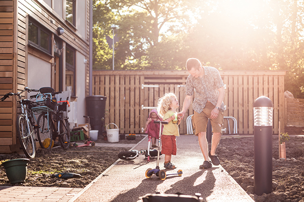 father and son play outside Lilac housing community