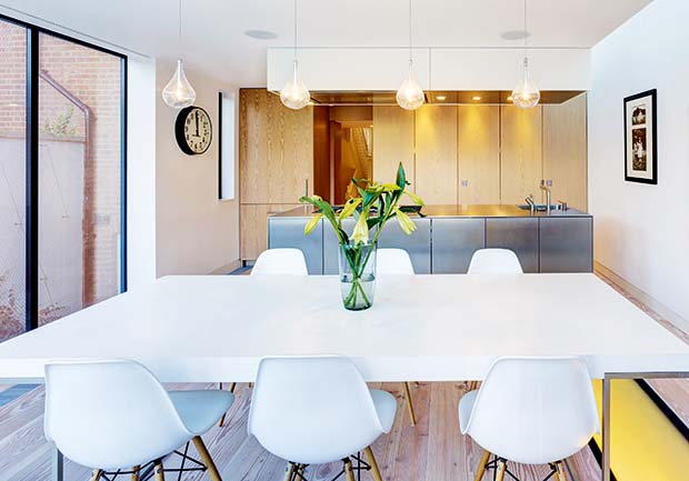 A kitchen diner in a modern extension with pendant lights