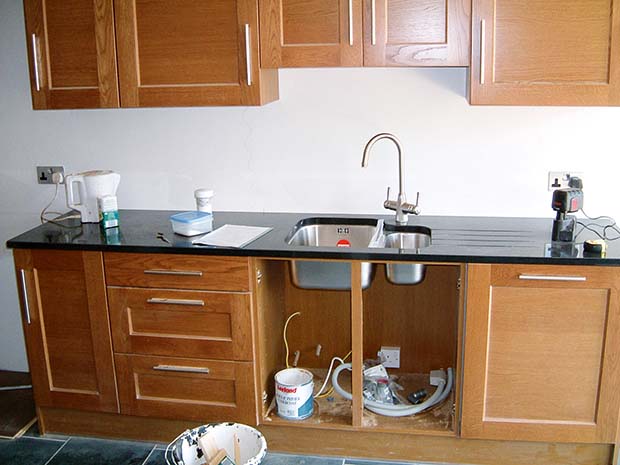 Second fix, electrics, plumbing, flooring fitted, and kitchen units installed
