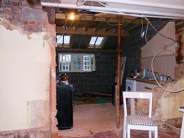 The kitchen extension with exposed wires and pipes