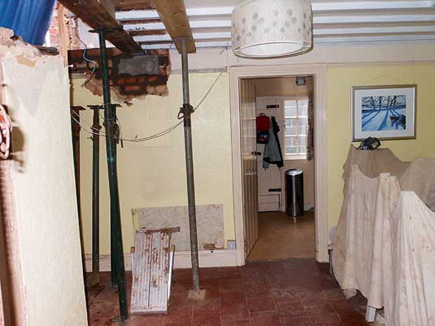 Covering the house in dust sheets and exposed brickwork and wires
