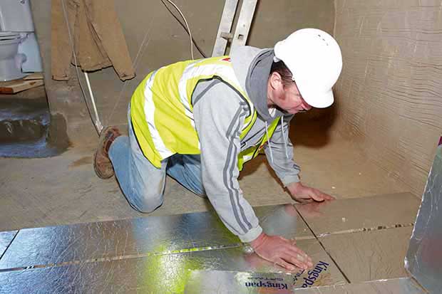 Man installing Kingspan Vacuum Insulated Panels