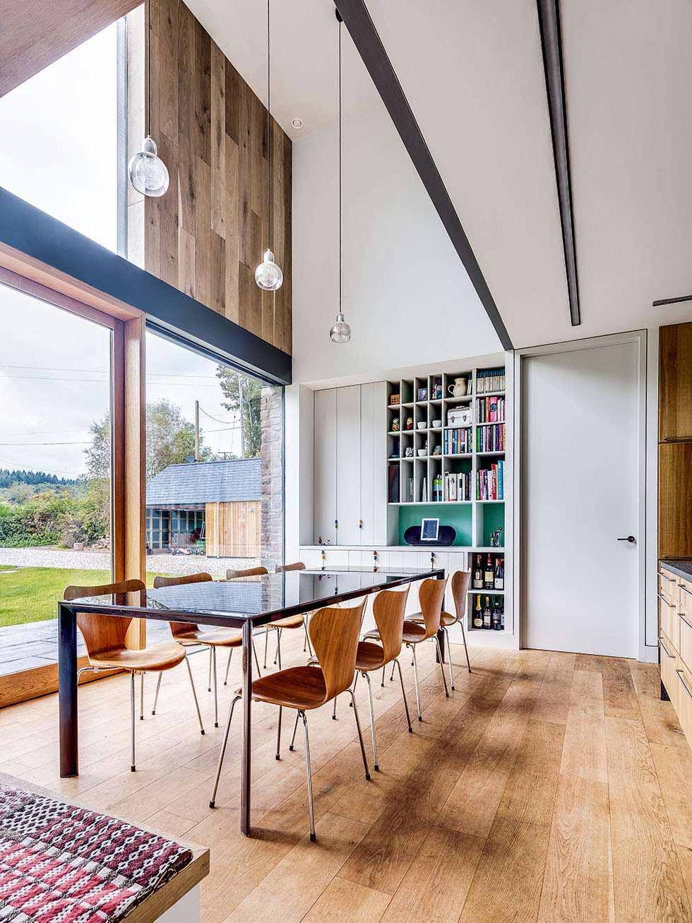 Double-height dining space with engineered floorboards
