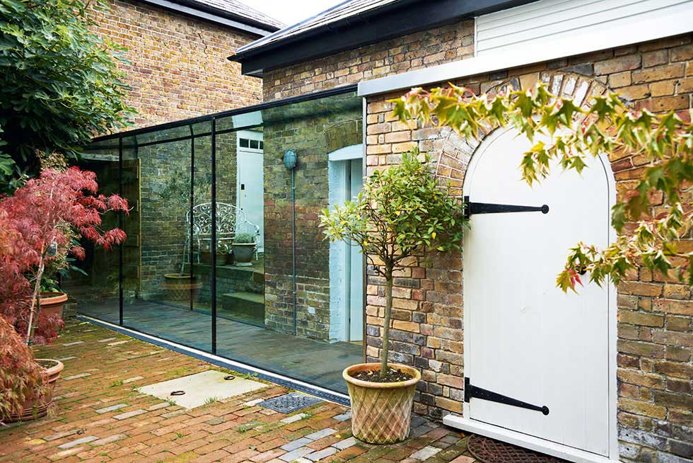Glazed corridor extension by Emrys Architects
