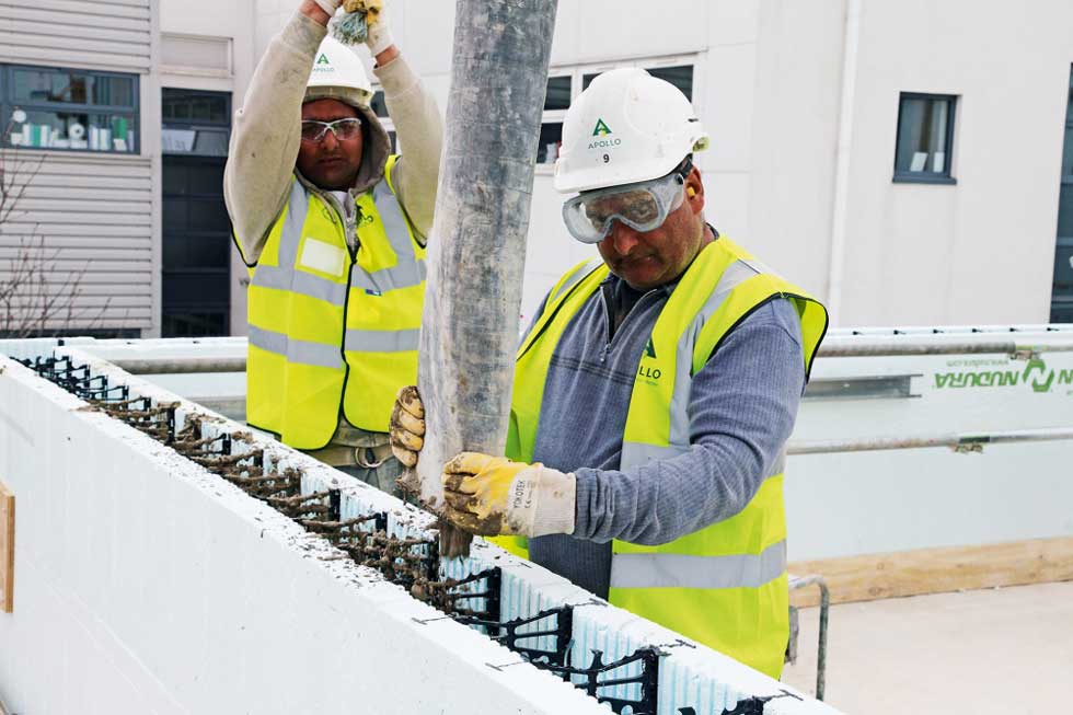 builders filling ICF EPS cavity with concrete