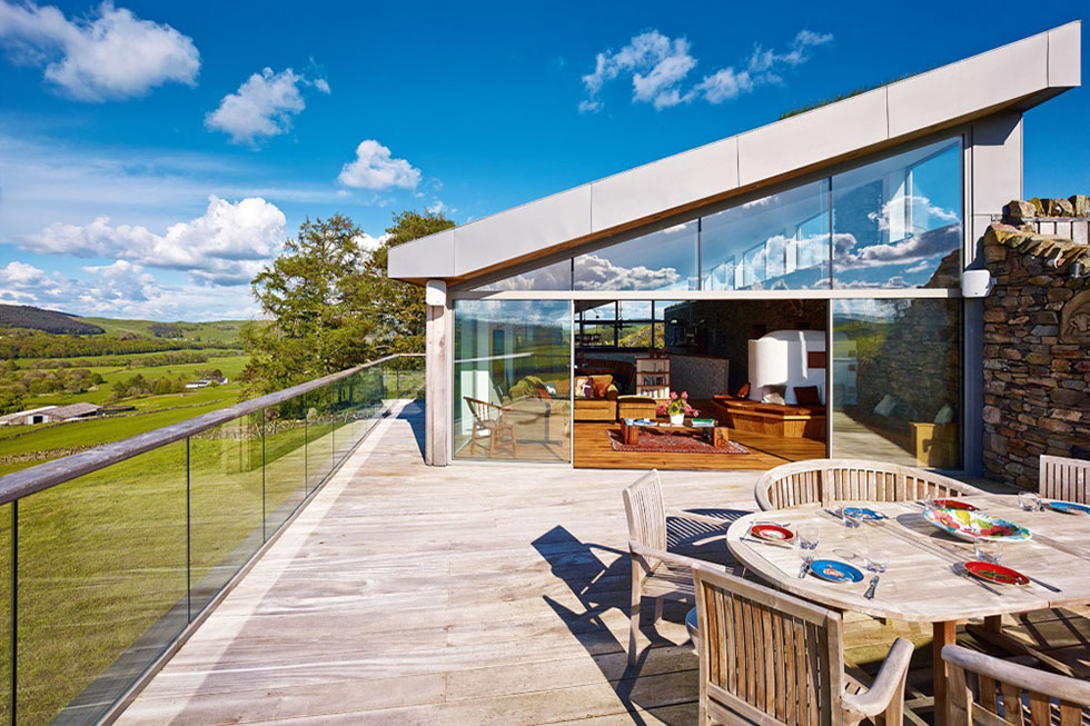 A living area opens out onto a roof deck for al fresco dining, taking advantage of upside-down living to maximise rural views across the 300-acre site. View Project →