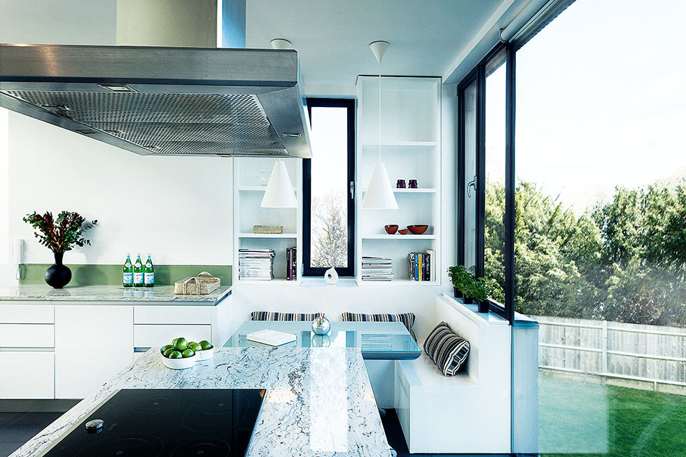 A snug kitchen seating area has been built beside the window to maximise views. View Project →