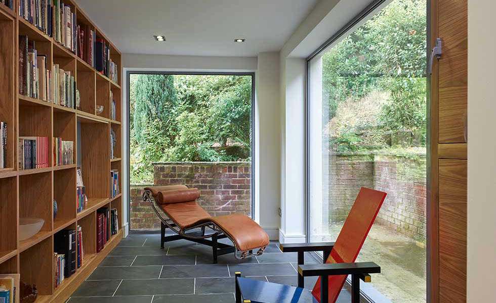 book shelves in a library with large windows