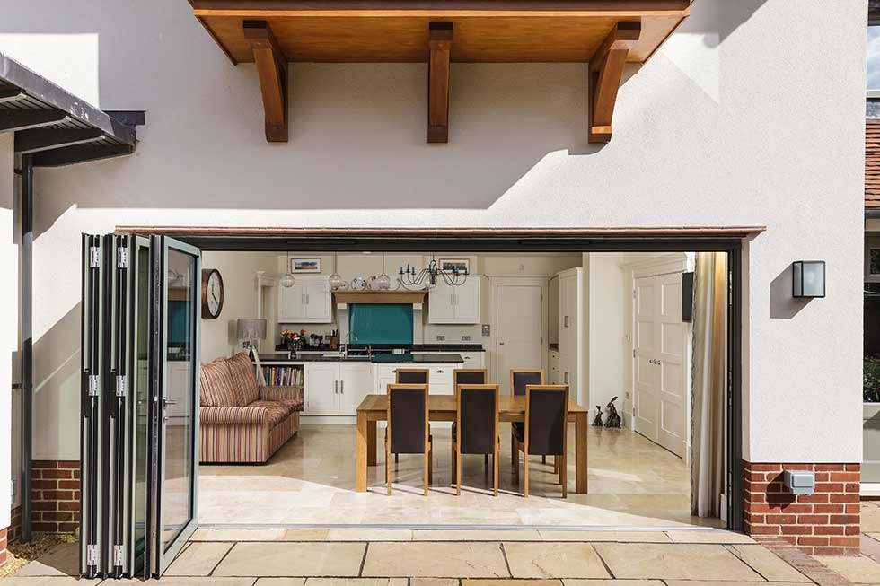 arts & crafts style self build house folding doors