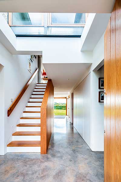 Old cottage extension wood staircase in glazed link