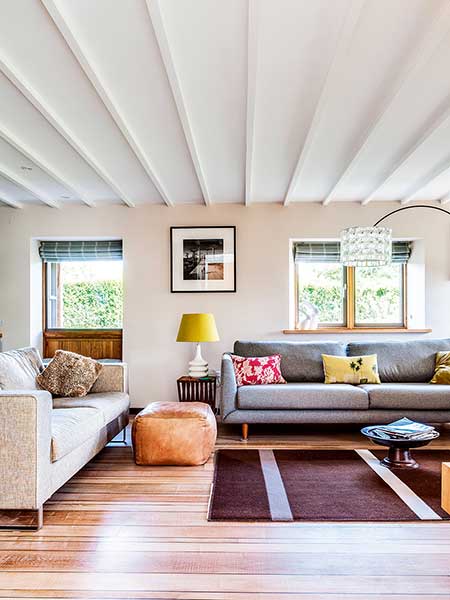 Old cottage extension cosy living room white beams