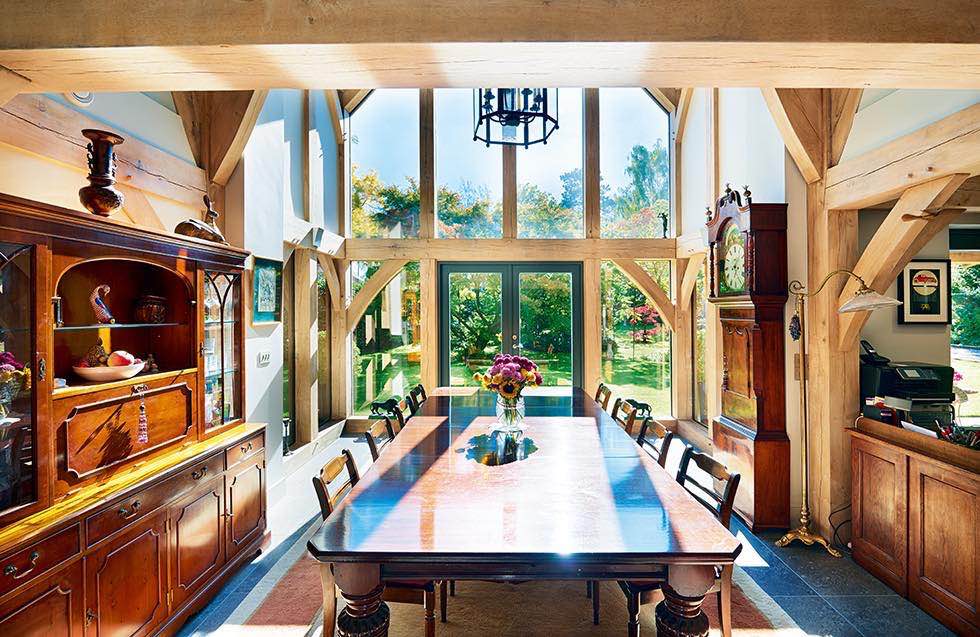 Oakwrights timber frame home double height dining room table chairs