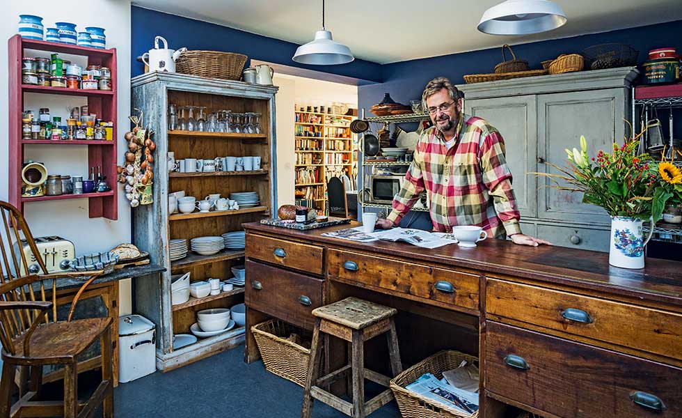 Nigel Humphrey in renovated kitchen with shopcounter and upcycled storage