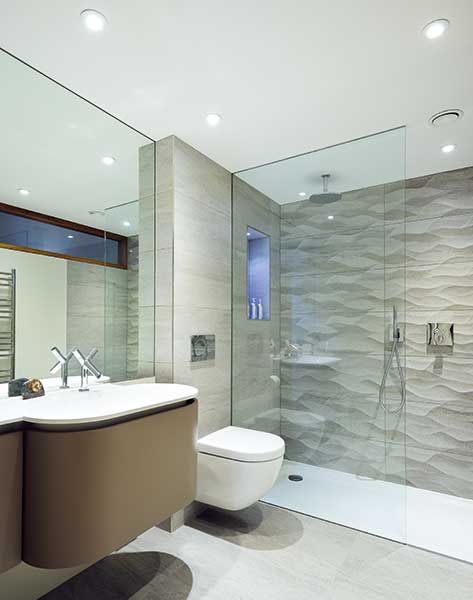 bathroom with grey tiles and walk-in shower
