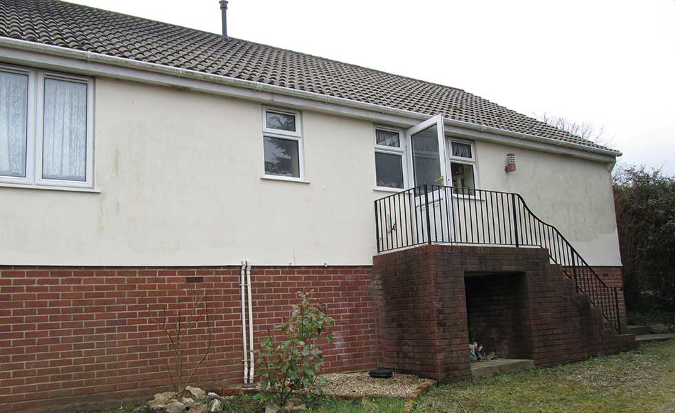 chalet bungalow on a sloping site before remodel