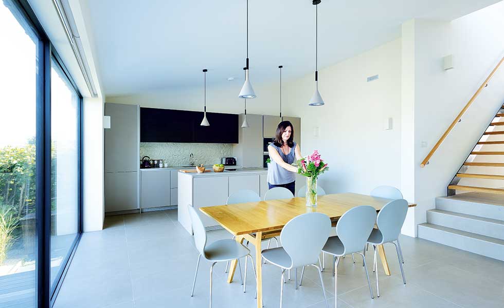 Sarah Catrwright in kitchen diner of her converted bungalow