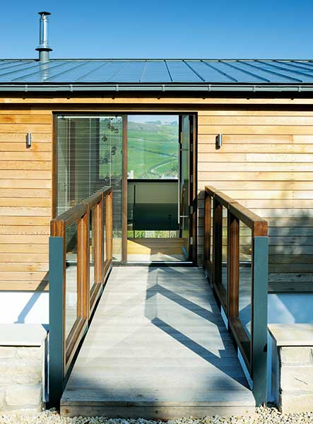 walkway to entrance and clad exterior of converted bungalow