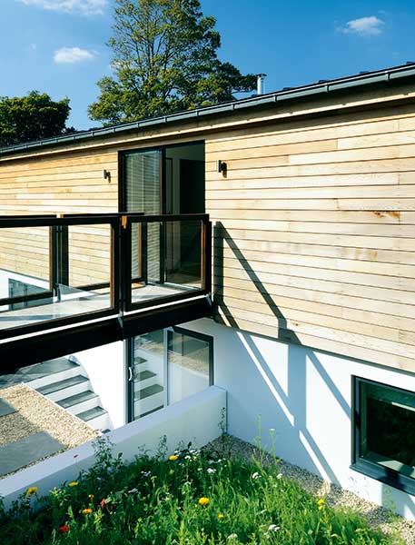 walkway to entrance of clad bungalow home
