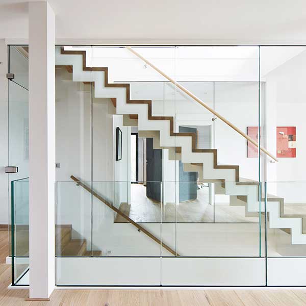 glass panels looking over double staircase with white and wood stairs