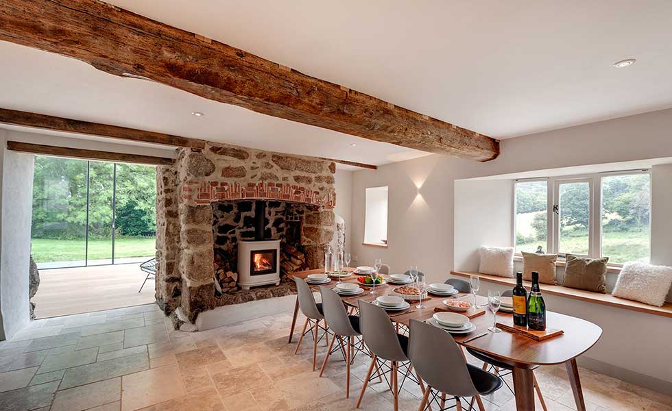 dining space in modern glass conservatory with original farmhouse features