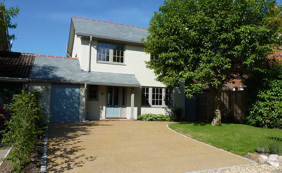 remodelled home with fresh white render and new doors and windows