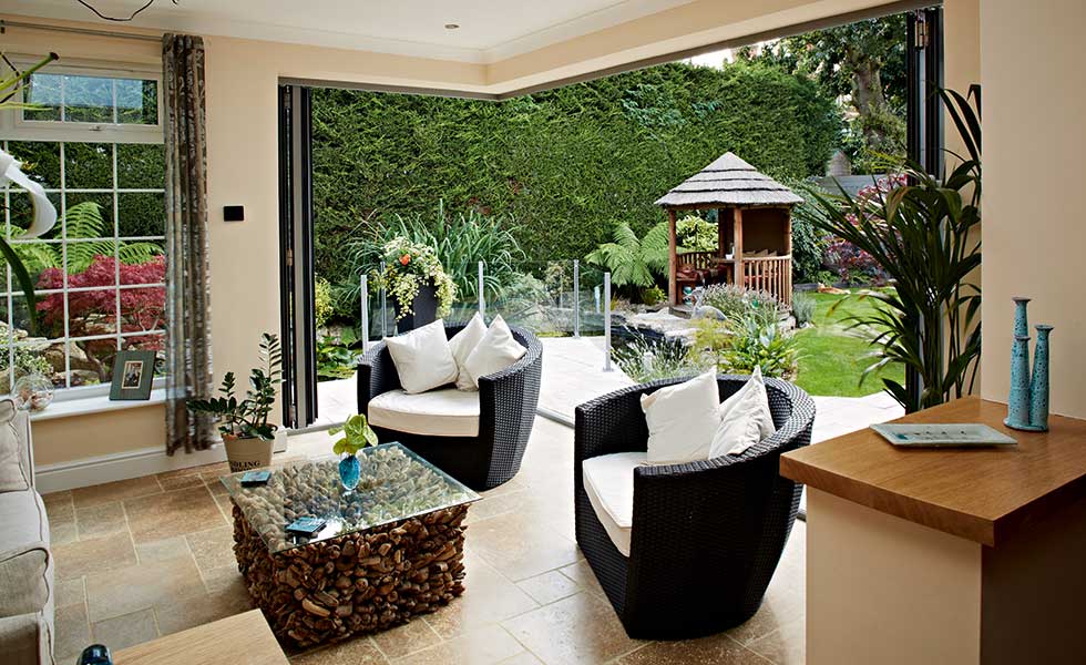 open corner with bi-fold doors to garden from living room