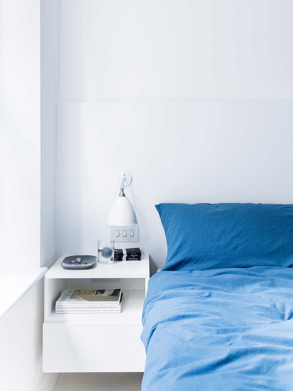 london flat white bedroom blue bedding bedside table