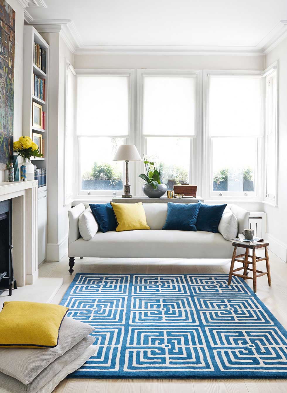 Open plan living room with blue rug by Jennifer Manners