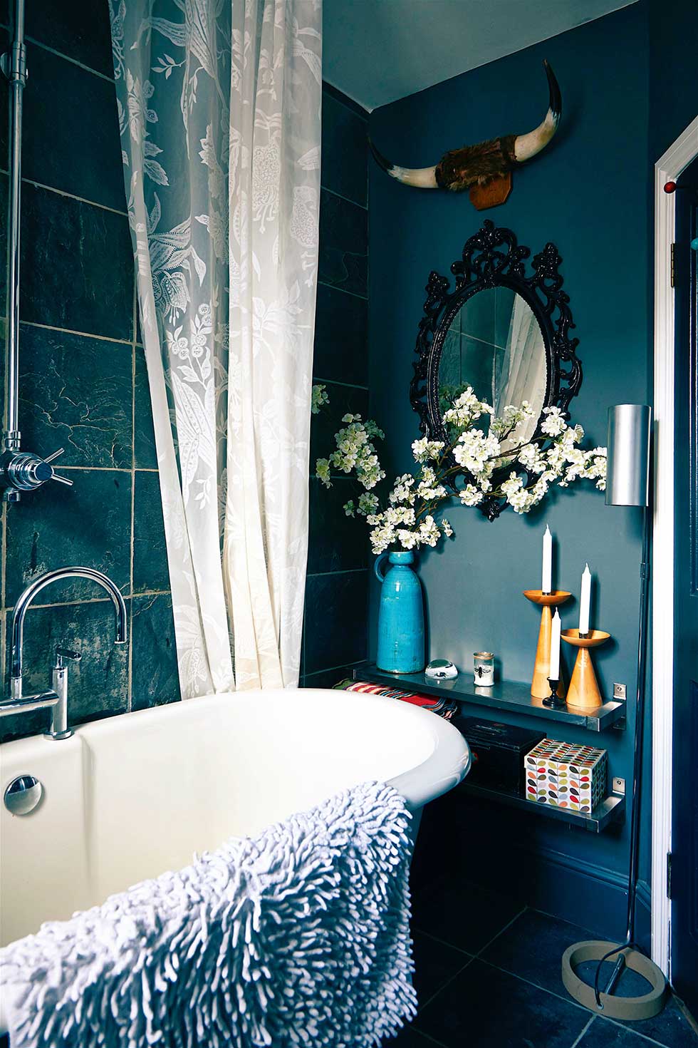 Duplex apartment roll top bath in dark bathroom