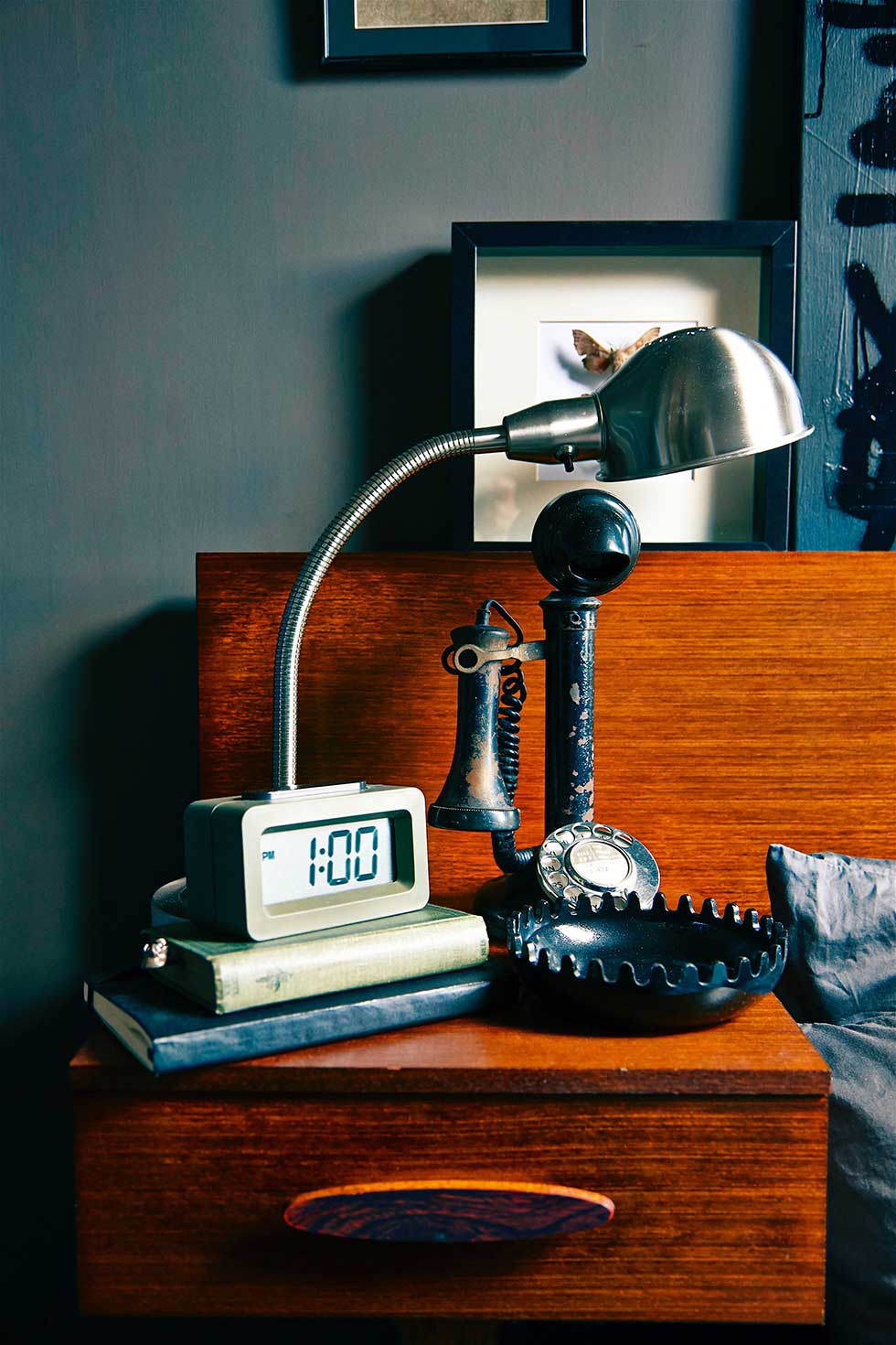 Duplex apartment mid-century bedaide table in dark bedroom