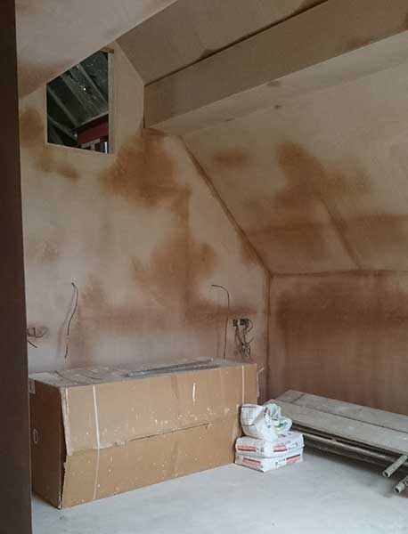 vaulted ceiling interior of a renovated and extended home with drying plaster