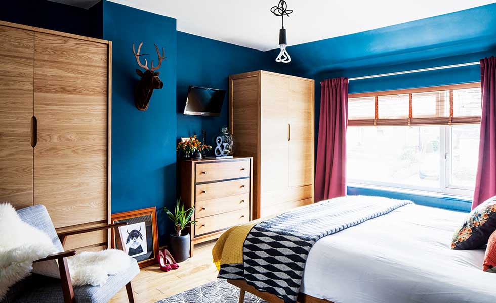 blue bedroom with midcentury style furniture