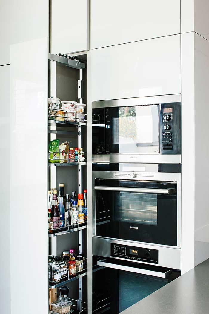 built in floor to ceiling larder and built in miele appliances in an architectural kitchen extension