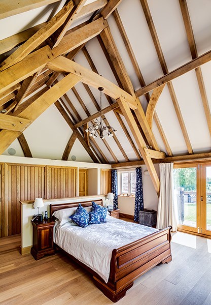 oak frame vaulted ceiling in a bedroom