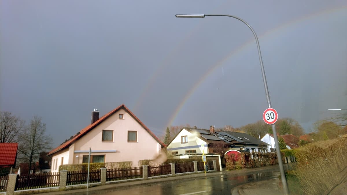 Regenbogen über Häusern am Himmel