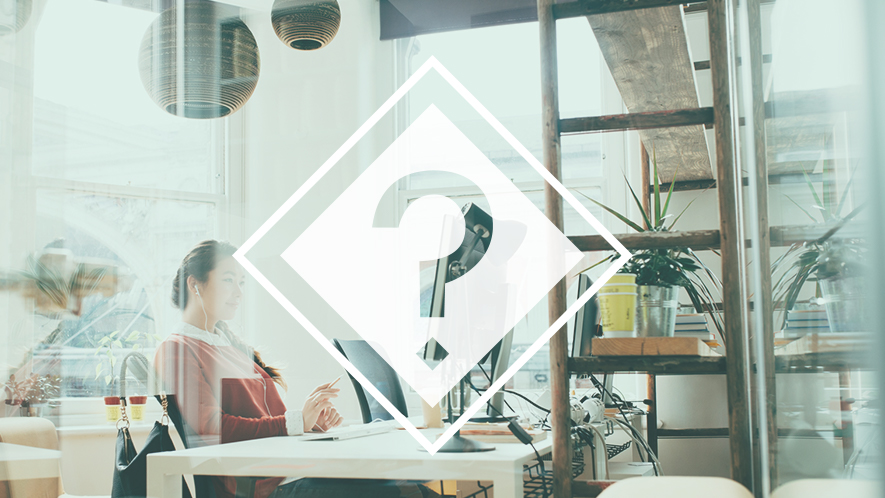 Fragezeichen vor Frau am Arbeitsplatz