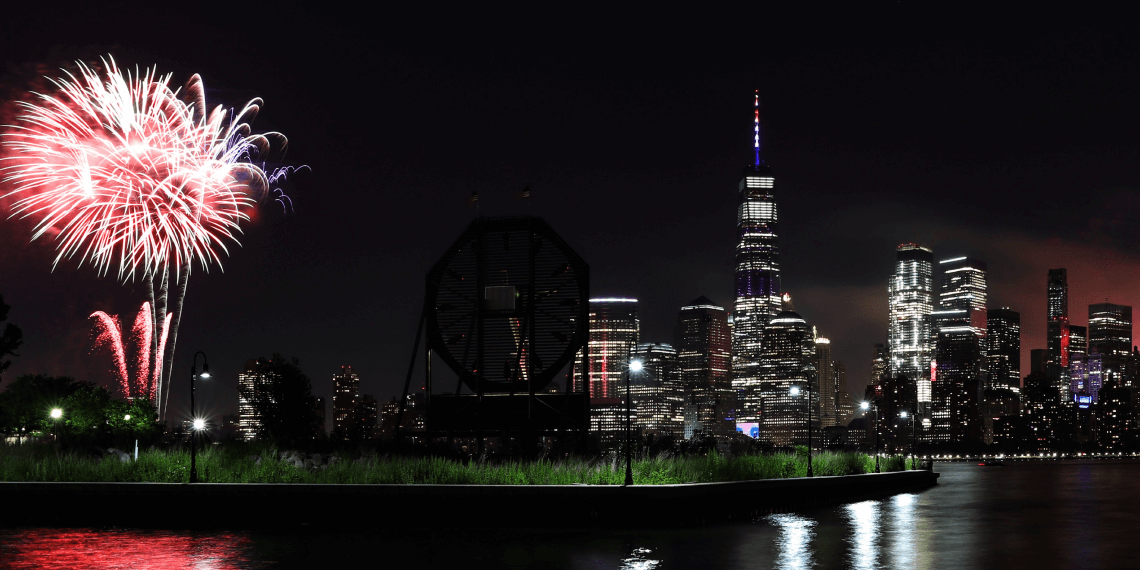 Take a FlixBus to your New Year's Eve party! Fireworks reflecting in water with New York cityscape