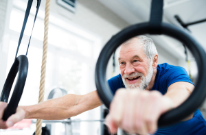Mann trainiert an Ringen im Fitnessstudio Mann trainiert an Ringen im Fitnessstudio