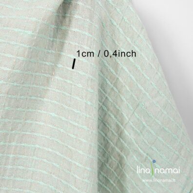 Lininis audinys žalsvas, su rombų ir punktyrinių linijų langeliais