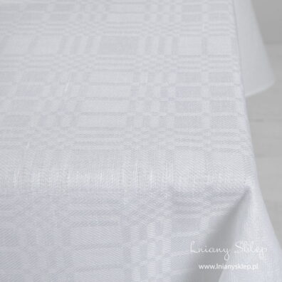 Biały lniany obrus w kratkę. Zbliżenie.