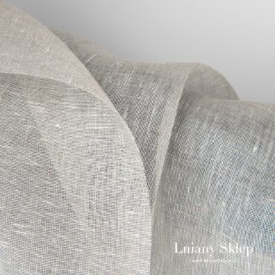 Przeźroczysta melanżowa tkanina lniana z przędzy białej i szarej.