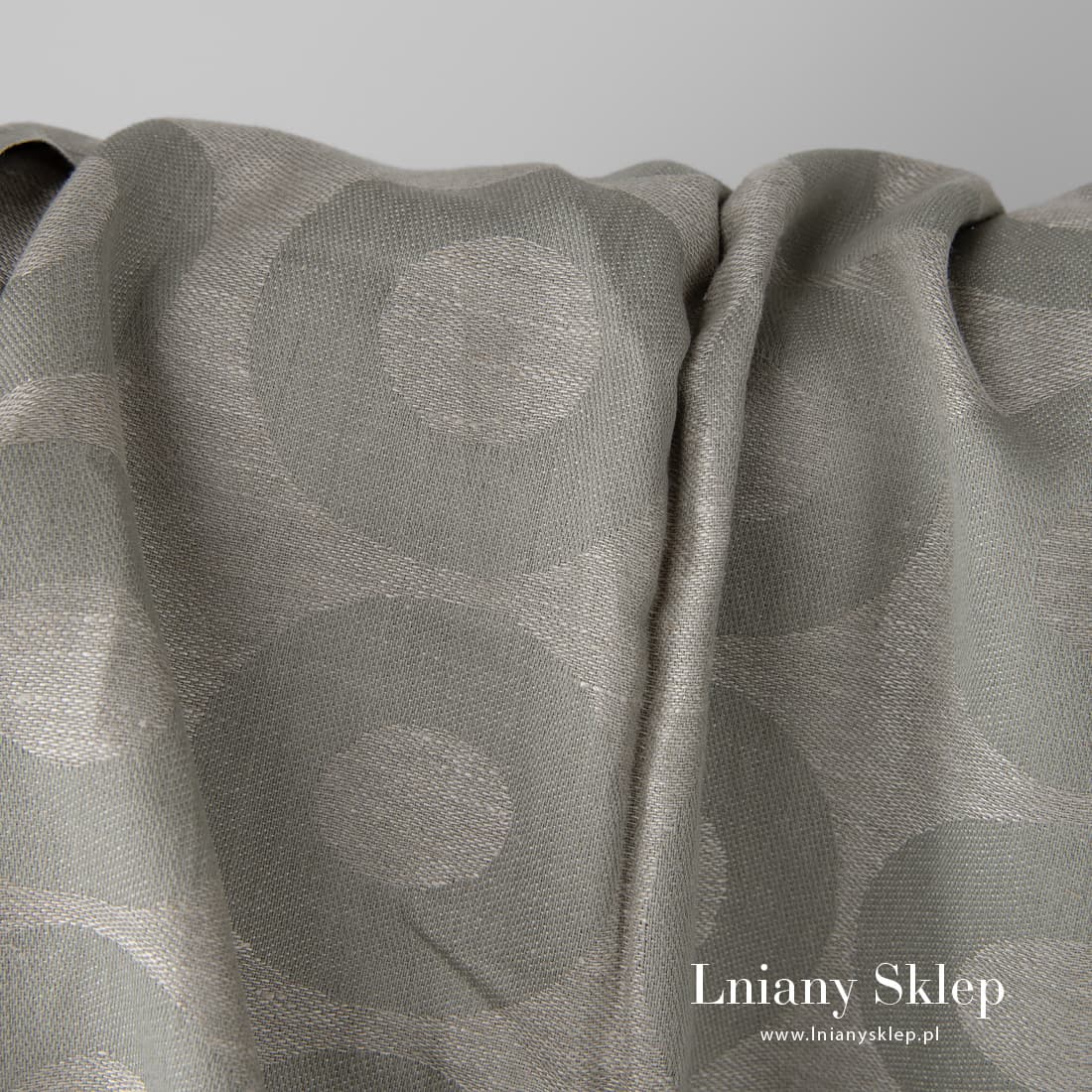 Gęsta, średnio gęsta ciężka szara tkanina żakardowa.