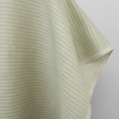 Jasnozielona tkanina o ciekawej fakturze.