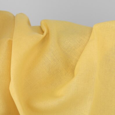 Jaskrawa żółta tkanina lniano-bawełniana wytkana splotem płóciennym.