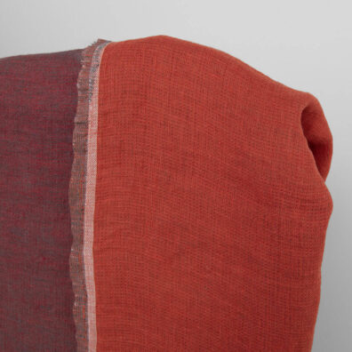 Jedna ze stron tej tkaniny lnianej - jasnoczerwona, druga jest czerwono – szara.