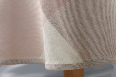 Brzeg obrusu wykończono szarą lamówką.