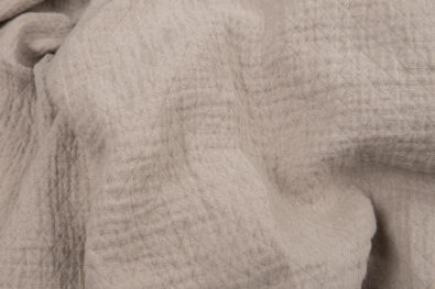 Szara prana tkanina lniana wytkana w romby.