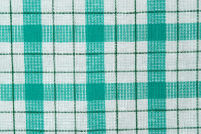 Tkanina (splot waflowy) w biało - zieloną kratkę.