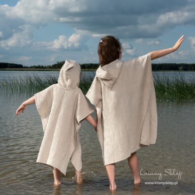 Jasne piaskowe ponczo dziecięce z kapturem.